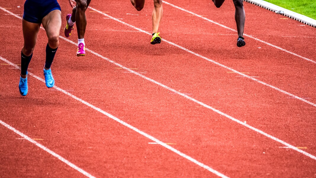 The photo shows a tartan track during an Athletics competition.