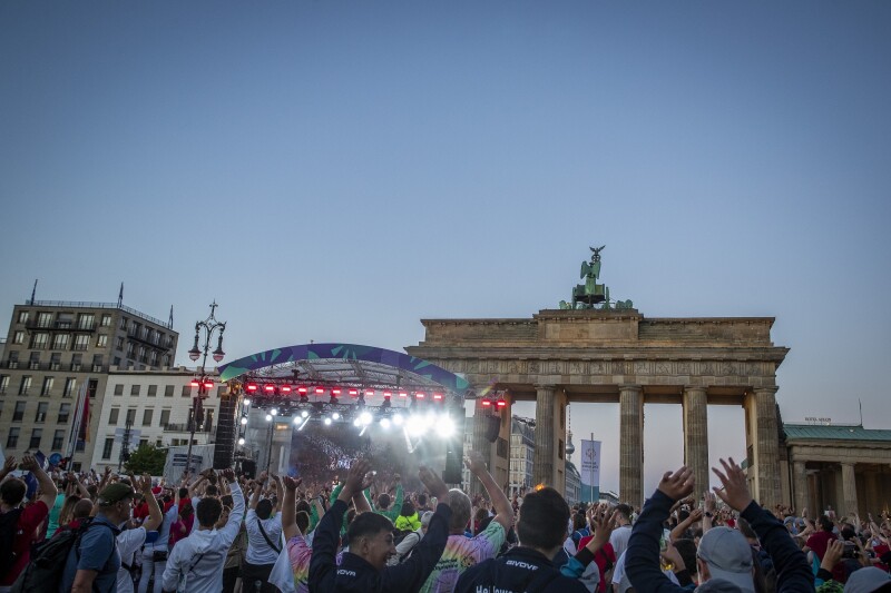 The photo shows a celebration scene during the Athletes' Party 2022 at the Brandenburg Gate.