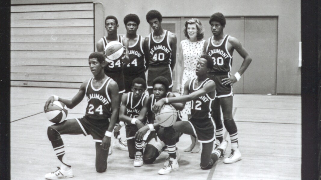 The photo shows Eunice Kennedy Shriver and a basketball team during the 1972 Special Olympics World Games with a basketball.