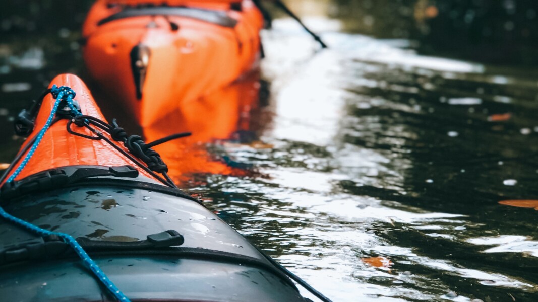 The photo shows two kayaks on the water.