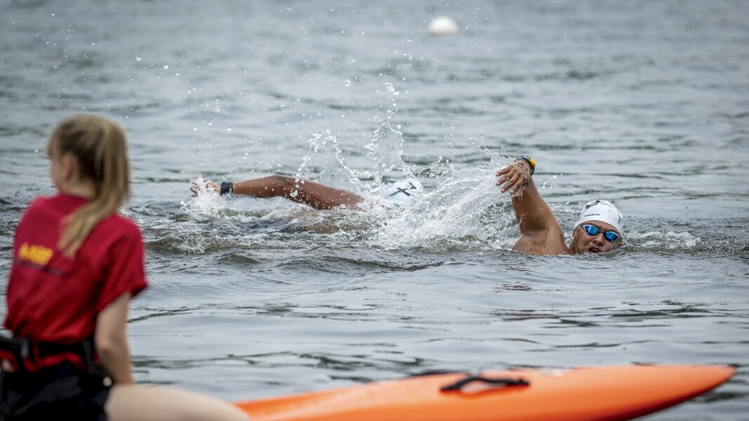 The photo shows an action scene during open water swimming.