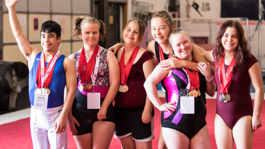 The photo shows athletes hugging each other.