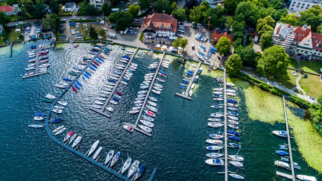 The photo shows a bird's eye view of a sailboat harbor.