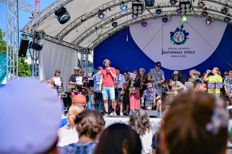 The photo shows the cultural stage at the Special Olympics Festival. On it is a band.