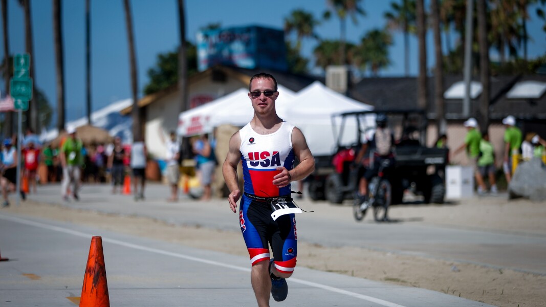 A photo of an athlete running at a Triathlon competition.