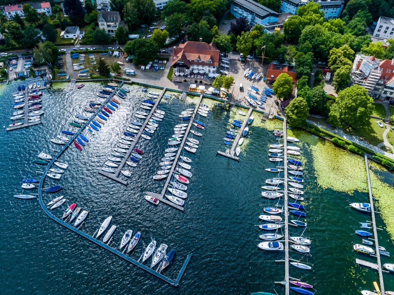 The photo shows a bird's eye view of a sailboat harbor.