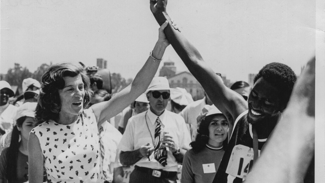 The photo shows Eunice Kennedy Shriver cheering with an athlete.