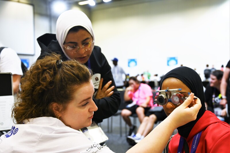 The photo shows an athlete taking an eye test. This is an offer from #Berlin2023