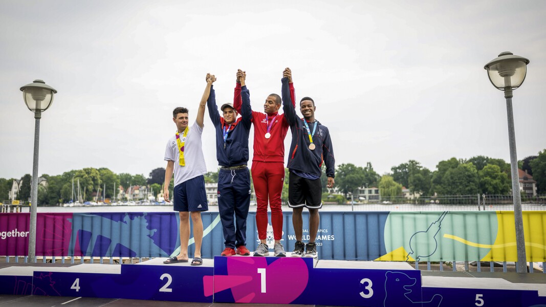 Victory ceremony presenting four athletes from Italy, Puerto Rico, Trinidad and Tobago and Cayman islands celebrating their respective victories in the swimming competition