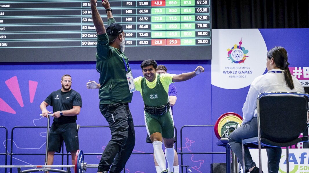 Saifullah Solangi from Pakistan running towards his coach and celebrating with big smile on his face