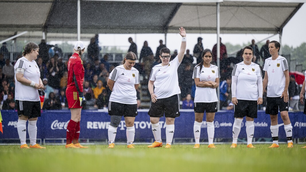 On the photo you can see the German women's national football team in official lineup before the start of the match. It's raining hard, but everyone seems to be in a good mood anyway. .