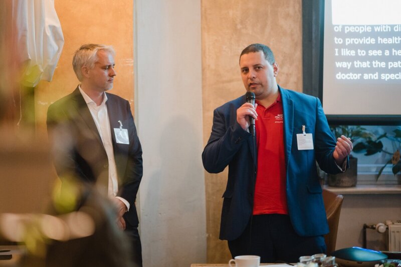 The photo shows SOD Health Ambassador Reynaldo Montoya as he gives a presentation. The photo was taken at a World Health Organization (WHO) conference as part of the 2022 World Health Summit.