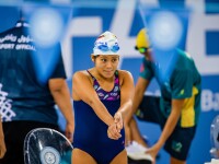 The photo shows a female swimmer getting ready before competition.