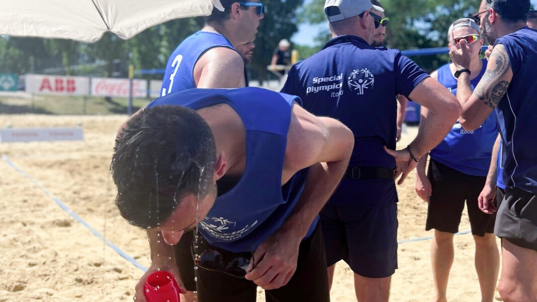 In the photo, an athlete pours water over his head during a break in beach volleyball. It was over 30 degrees.