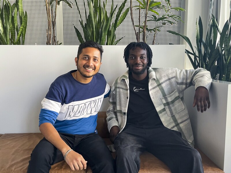 The photo shows Saurabh Mishra and Larry Boateng, both members of the World Games team in the Volunteers section. They are sitting relaxed on a sofa and looking friendly into the camera.