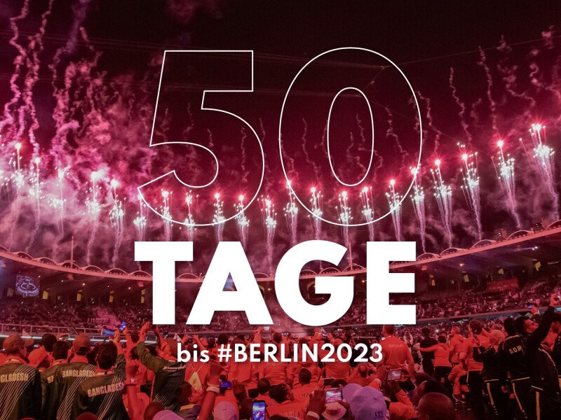 Auf dem Foto sind viele Menschen und Feuerwerk zu sehen. Und der Schriftzug 50 Tage bis #Berlin2023
