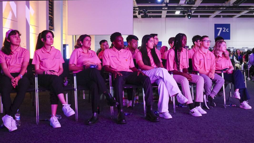 The photo shows participants at the GYF. They are the Global Youth Council. They are listening with interest.