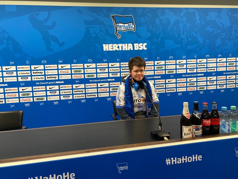 The photo shows Arthur Hackenthal on a media seat of Hertha BSC, which is usually occupied during the press conference. He is completely dressed in fan gear.