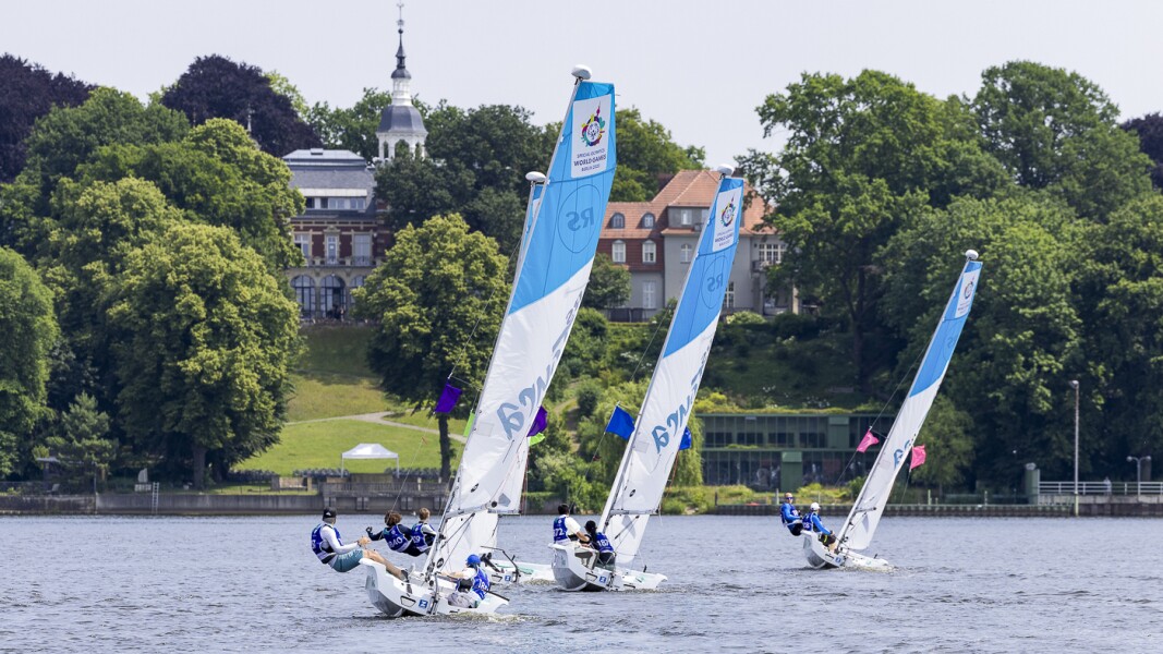 Three sail boats with sailors competing at Club Seglerhaus in Wannsee.