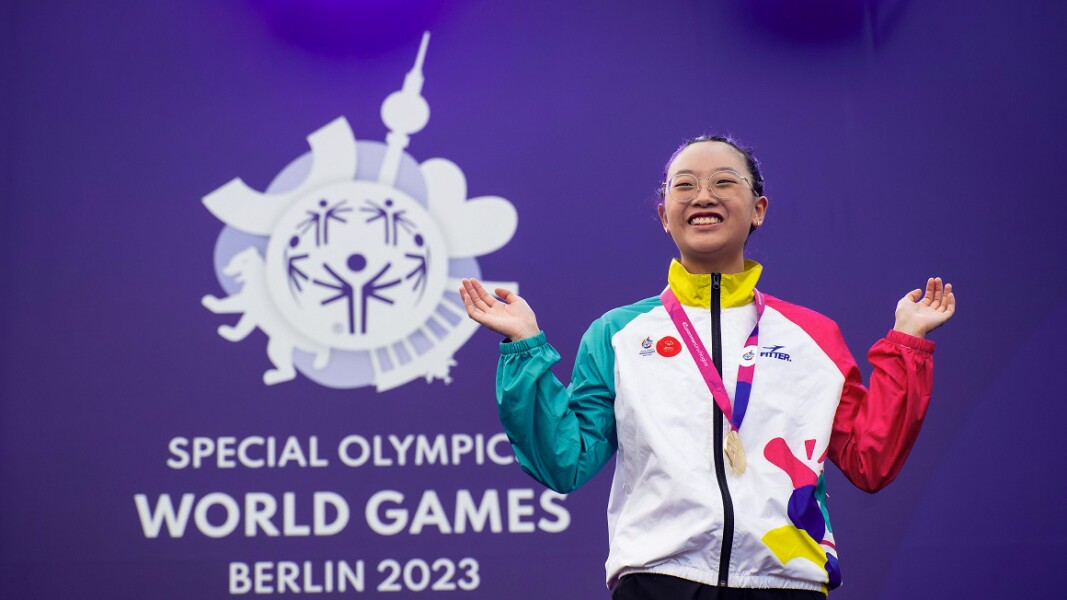 Wai from Hong Kong celebrating the very first gold medal of the special olympics world games 2023 with big smile on her face.