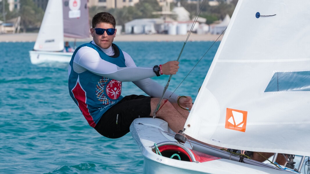 The photo shows an athlete during a sailing competition.