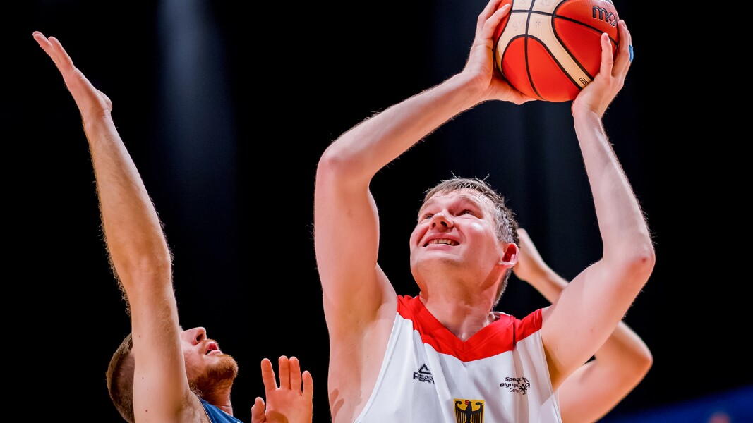 A Basketball player tries to score during a match.
