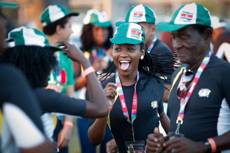 The photo shows athletes celebrating and dancing exuberantly.