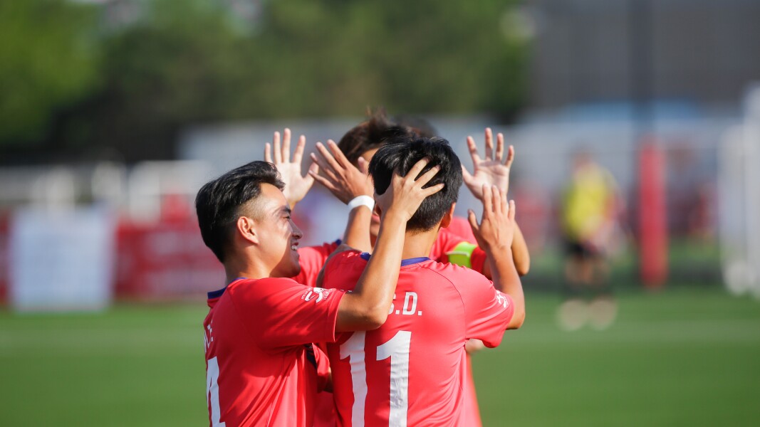 Das Foto zeigt drei Spieler aus einem Tea. Sie jubeln und beglückwünschen sich.