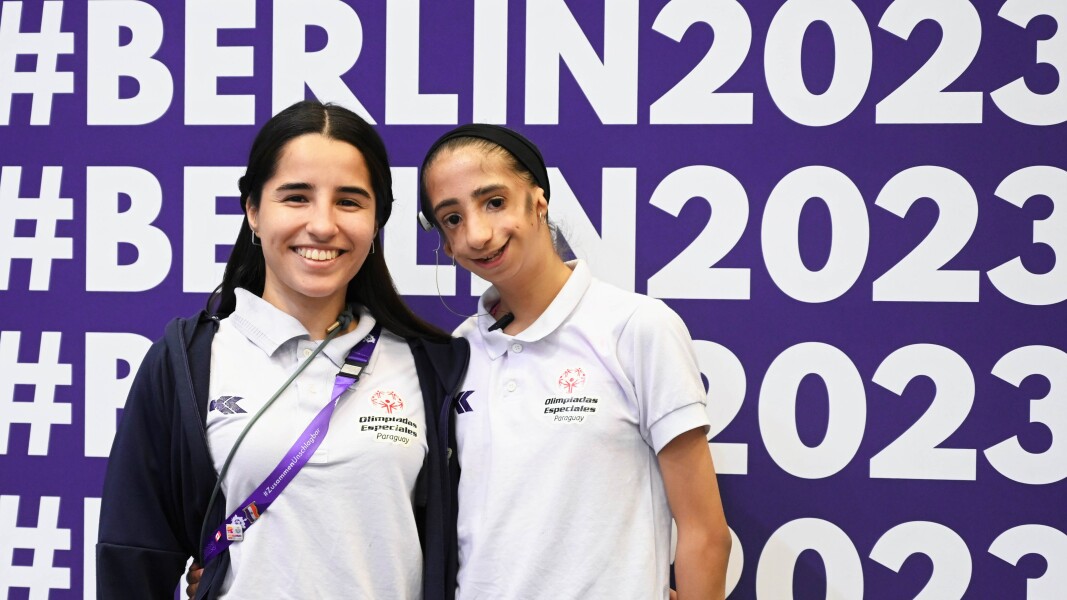 On the picture you can see a young gymnastics-rhythmic athlete with her coach.