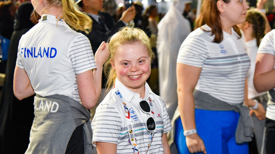 In the photo a Finnish athlete laughs into the camera.