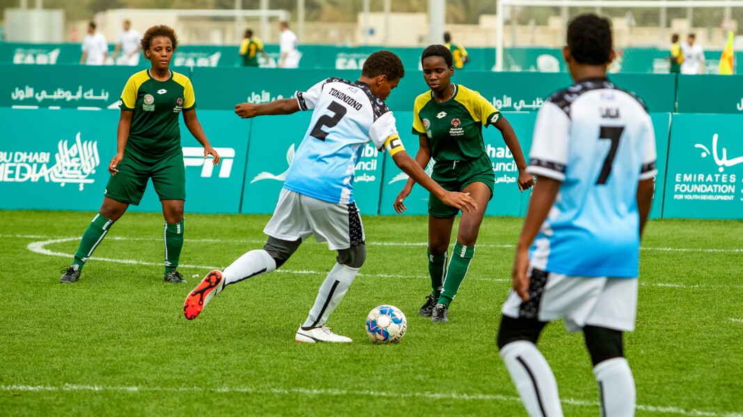 Auf dem Foto ist eine Spielszene mit vier Spieler*innen beim Futsal zu sehen.