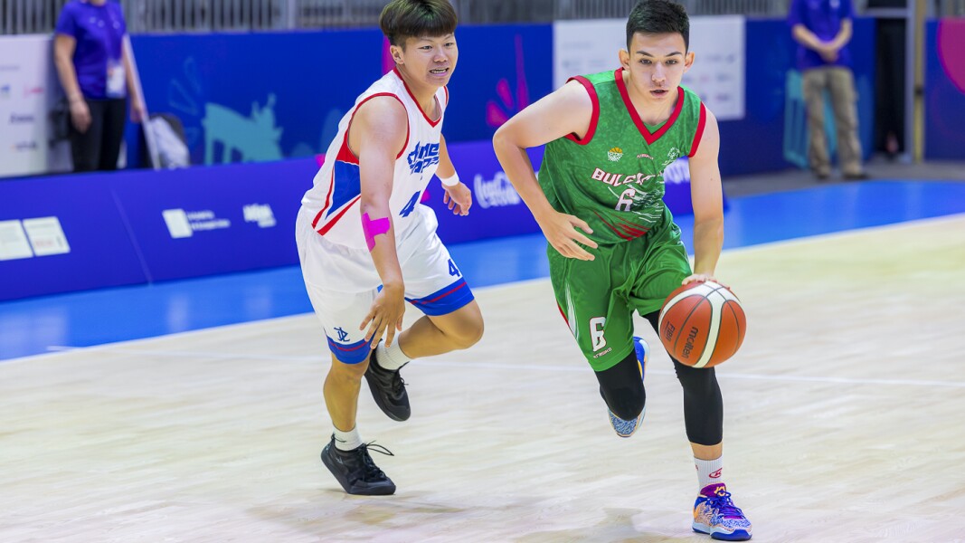 On the picture you can see two athletes playing basketball against each other.