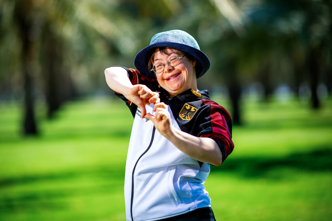 The photo shows an athlete forming a heart with her fingers.