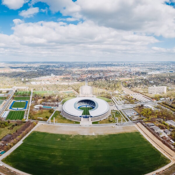 The photo shows an aerial view of the Olympic Park site.