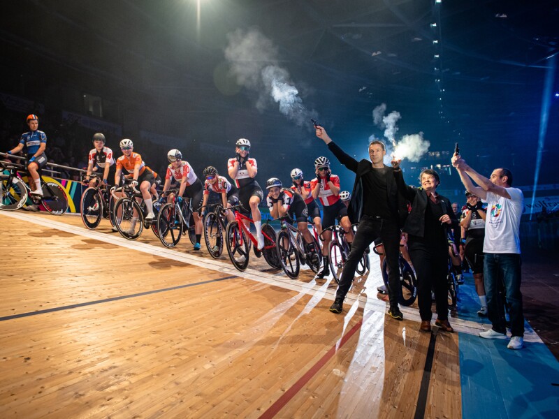 On the photo you can see cyclists and the people who give the starting signal