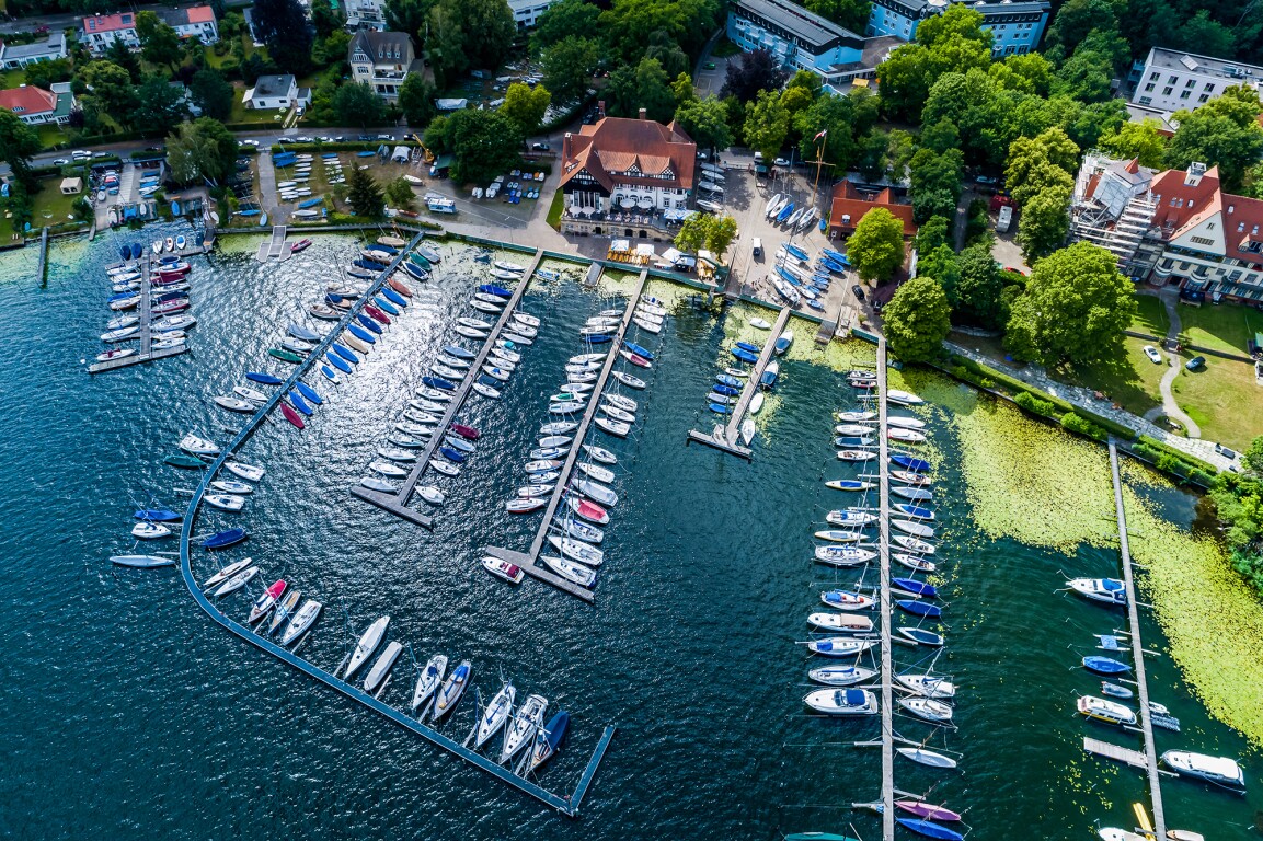 The photo shows a bird's eye view of a sailboat harbor.