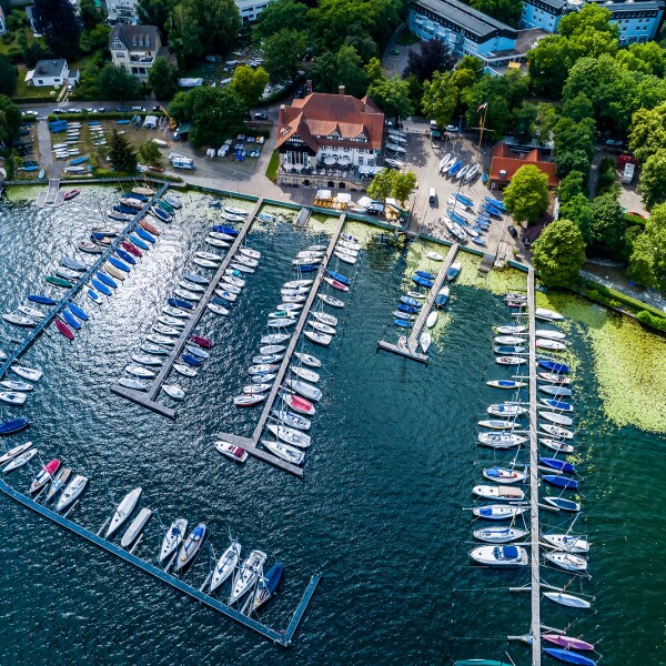 The photo shows a bird's eye view of a sailboat harbor.