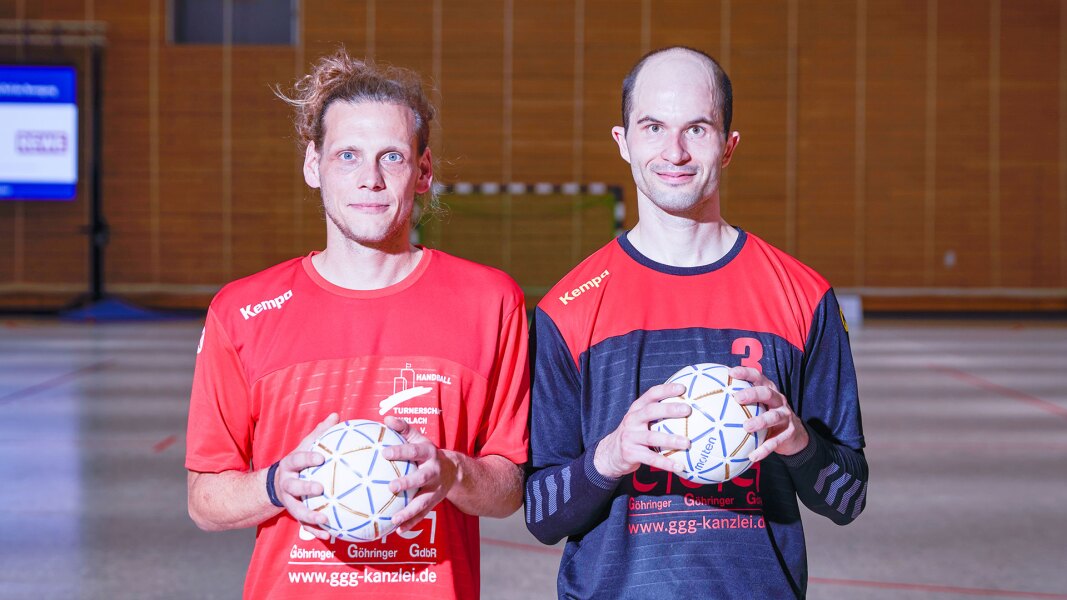 On the photo there are two athletes holding a handball in their hands each and looking at the camera. They are part of a Unified handball team.
